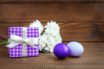 Fototapeta na wymiar Gift and Eggs. Concept Happy Easter.