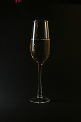 Glasses with white wine on black background. you can place your text