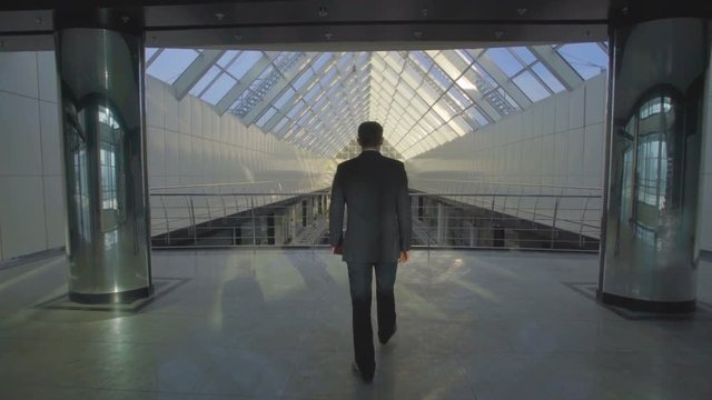 The businessman walk in the business center balcony. Slow motion