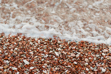 Pebbles on the beach. Texture of the sea shore. The Adriatic Sea in Montenegro.