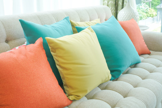 Closeup colorful pillows on sofa in modern living room