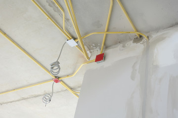 Wiring work for electrical system under concrete floor at construction site