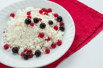Homemade cottage cheese with red and black currants
