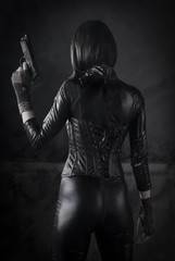 Fototapeta na wymiar Female Assassin with gun