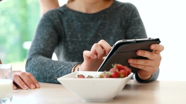 couple enjoying time together while eatinga and using technology