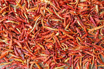 Dried red hot chilli peppers on bamboo weave basket