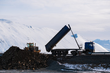 Dumping truck with Bulldozer working at dam site construction