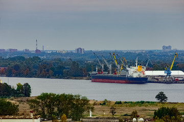 Fototapeta premium Cargo ship (bulk carrier) loading in port at Riga, Latvia