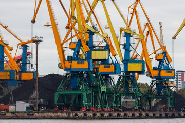 Fototapeta na wymiar Yellow cargo cranes in the port of Riga, Europe