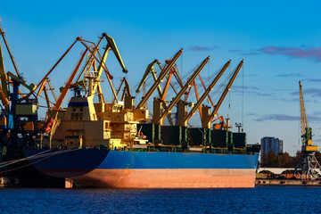 Blue cargo ship loading in the port of Riga, Europe