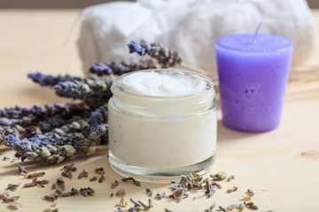Moisturizing cream and lavender on wooden background