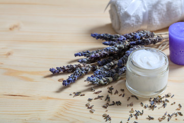 Fototapeta na wymiar Moisturizing cream and lavender on wooden background