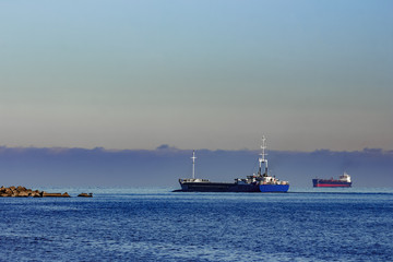 Blue cargo ship leaving Riga and entering Baltic sea
