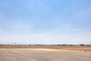 Fototapeta na wymiar Runway of small airport shot against a backdrop of blue sky