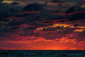 Red cloudy sunset sky over the Baltic sea
