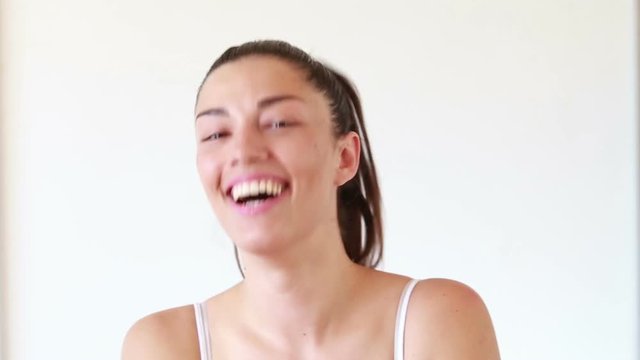 Close up portrait of young crazy woman making funny faces on isolated white background