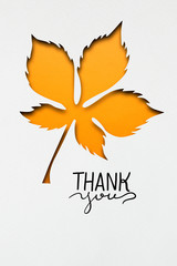Happy Thanksgiving day / Creative thanksgiving day concept photo of a leaf made of paper on white background.