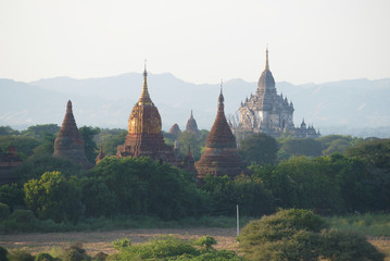 Tops of ancient Buddhist temples in an evening haze. Bagan, Myanmar