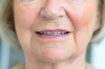 Lower face of a senior woman with lips ajar