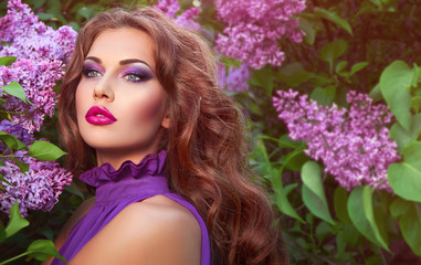 The girl's face. Beautiful girl with flowers. Lilac. Blue dress.