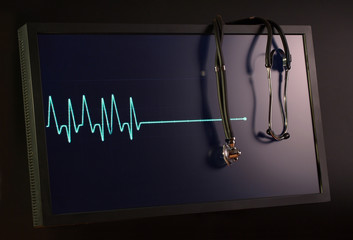 Fading cardiogram and stethoscope on the monitor