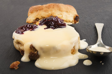 raisin scone with fresh custard on slate