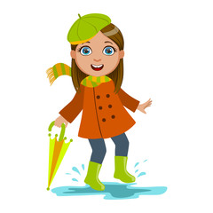 Fototapeta premium Girl In Green Beret With Umbrella, Kid In Autumn Clothes In Fall Season Enjoyingn Rain And Rainy Weather, Splashes And Puddles
