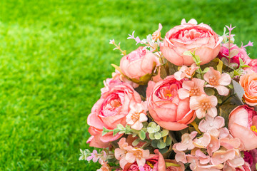 Beautiful of artificial flowers on grass