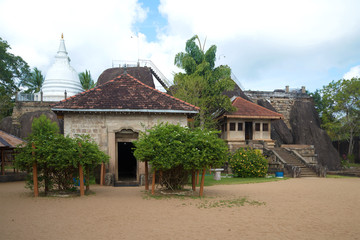Fototapeta na wymiar The ancient temple complex of Isurumuniya Vihara is a cloudy day. Anuradhapura, Sri Lanka