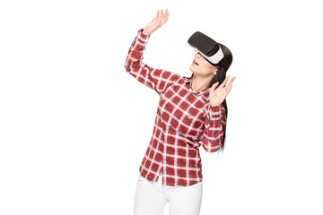 Shocked woman playing game in virtual reality and gesturing.
