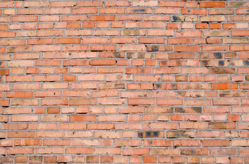 Naklejka premium Orange dirty brick wall background surface.