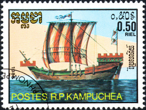 UKRAINE - CIRCA 2017: A postage stamp 0.50R printed in Cambodia shows old sailing ship cog, series Medieval Ships, circa 1986
