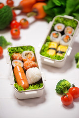 Bento box with different food, fresh veggies and fruits