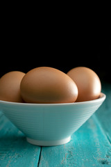 close up brown eggs on wood table still life photography.