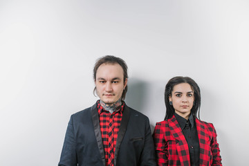 the guy with the girl in the red plaid shirt in a black jacket in the tattoo isolate a close-up look at the camera exactly copyspace