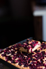 cherry fruit pie on a black tray on black background