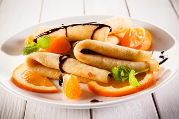 Crepes with fruits and cream