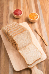 slices bread with jam on wooden table