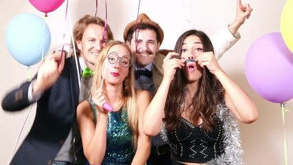 Four beautiful friends enjoying in party photo booth, graded - Powered by Adobe