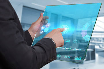 Technology Internet and network concept . Young business man working on the tablet of the future select the virtual screen