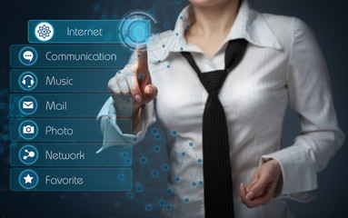 Business girl clicks on the buttons on the virtual screen