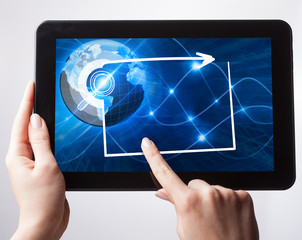 Young businessman working on the tablet select on the virtual display. Business Technology Internet and network concept.