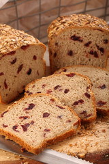 Whole grain bread with cranberry on a wooden board
