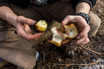 Baked potato in the hands of man. Top view.