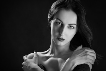 sensual woman with bare shoulders on black background monochrome