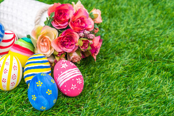 Easter eggs with artificial flower on Fresh Green Grass