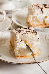 Fresh sweet apple cake with whipped cream served with cup of tea