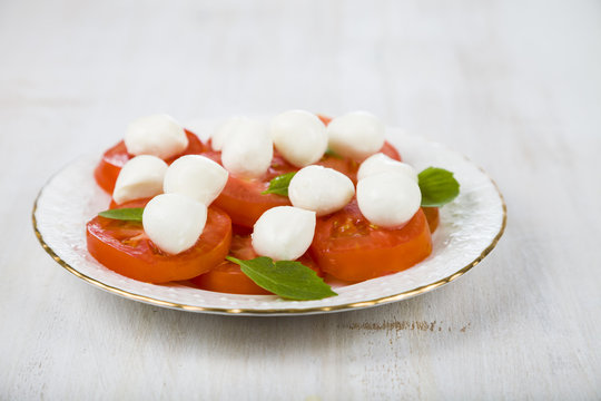 Caprese salad on a wooden table.