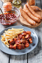 Traditional German currywurst - pieces of sausage with curry sau