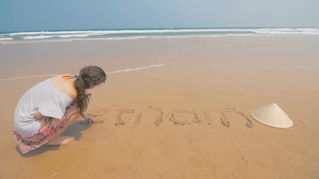 Young beautiful girl on a Vietnamese beach in the daytime